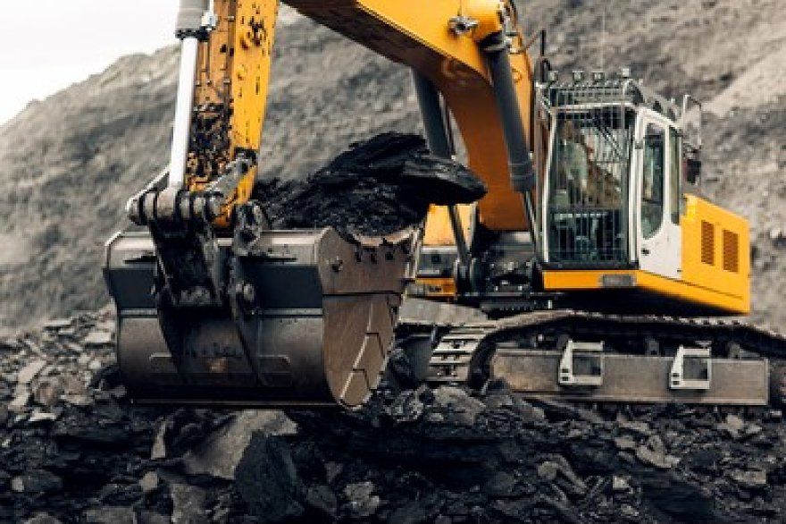Professional team inspecting industrial crushing equipment at mining site